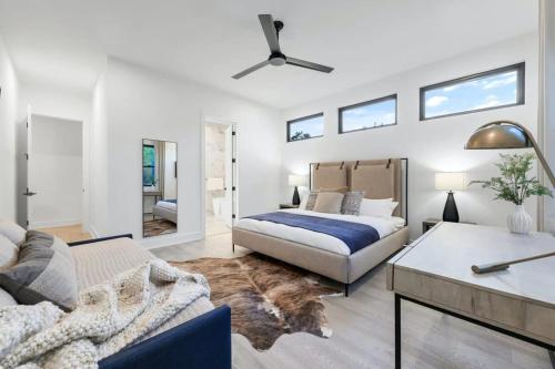 a living room with a bed and a couch at Stylish Southern Home with Heated Pool in Austin
