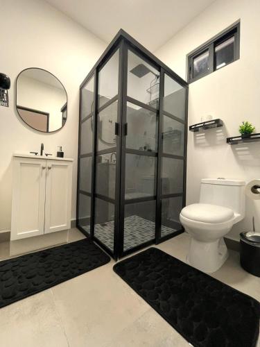 a bathroom with a shower with a toilet and a mirror at Habitara - Carancho in Atasta de Serra