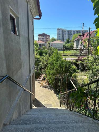 a stairway leading up to a building with a balcony at Maryams Studio Guesthouse in Zugdidi
