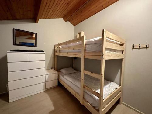 a bunk bed room with two bunk beds and a dresser at Vue sur Ourthe in Durbuy
