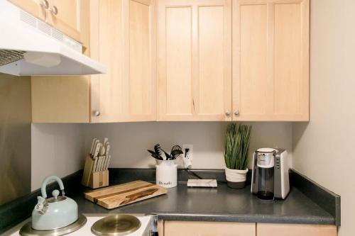 a kitchen with wooden cabinets and a black counter top at Perfect Small Family Beach Condo in Saint Simons Island