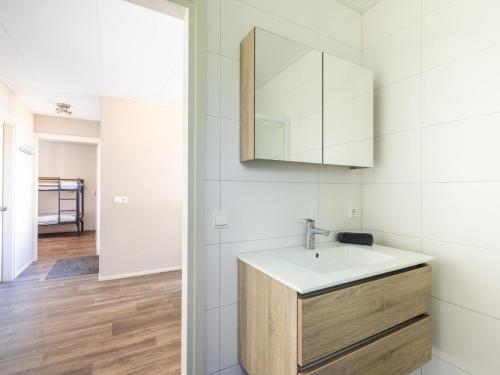 a bathroom with a sink and a mirror at Sluisje 15 in Kuinre