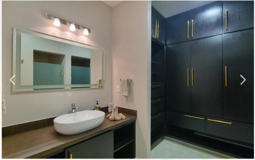a bathroom with a white sink and a mirror at Escape to Paradise in Tangolunda