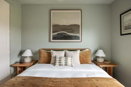 a bedroom with a large bed with two night stands at Modern Coastal Home with Heated Pool in Bay Saint Louis