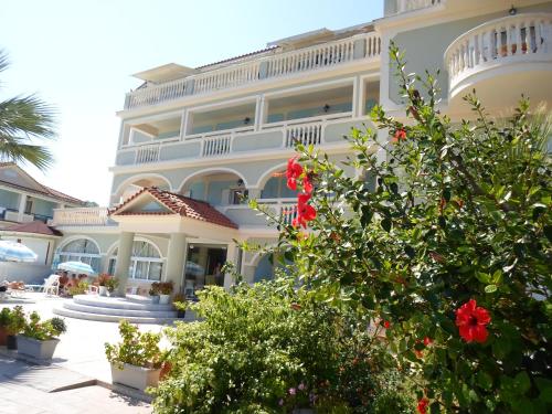 a large building with flowers in front of it at Hotel Villa Basil in Tsilivi