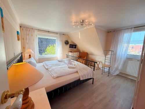 a bedroom with a large bed and a window at Villa del Sol in Büsum