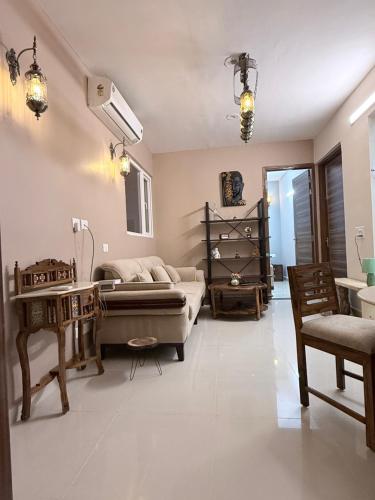 a living room with a couch and a table at Skypod13 in Chandīgarh