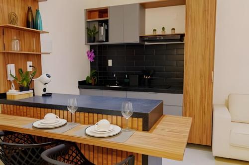 a kitchen with a table with hats on it at Studio Moderno com Internet e Garagem. in Três Corações