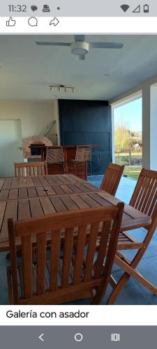a dining room with a wooden table and chairs at Casa Paradiso Salta in Salta