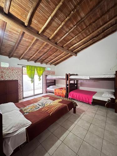 a bedroom with two bunk beds in it at Alegría Lodge in Curití