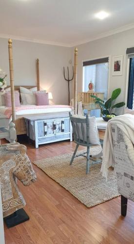 a bedroom with a bed and a table and chairs at Stylish Studio in Reedy Creek in Gold Coast