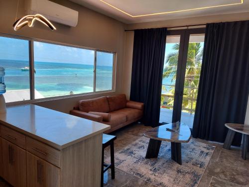 a living room with a view of the ocean at Caye Caulker Condos in Caye Caulker