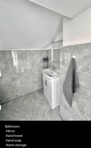 a bathroom with a toilet and a sink at Medway Hidden Gem in Gillingham