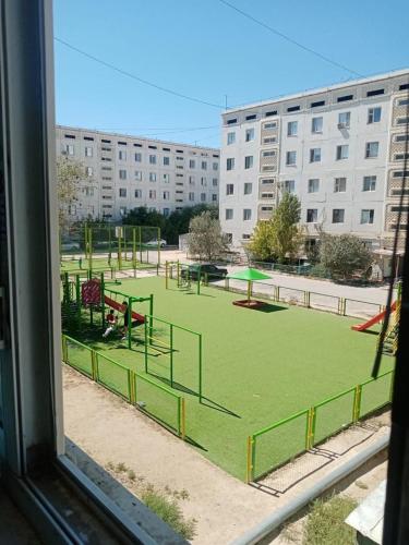 a view from a window of a park with a playground at Мерей 1 in Qyzylorda