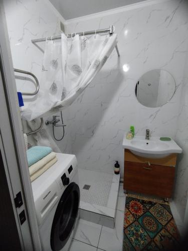 a bathroom with a sink and a washing machine at Мерей 1 in Qyzylorda