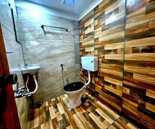 a bathroom with a toilet and a sink at Cascade View in Cochin