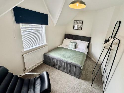 a small bedroom with a bed and a window at Comfortable 3BR house-parking close to city centre in Kidlington