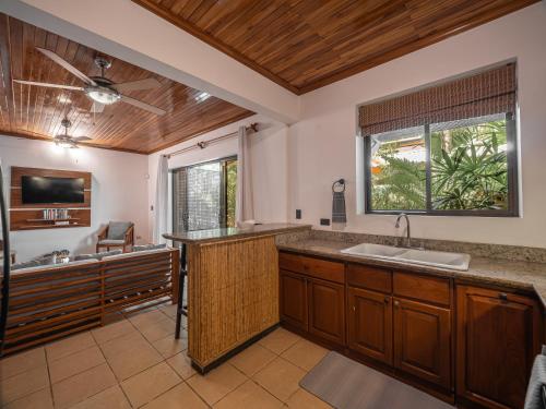 a large kitchen with a sink and a tub at Beach Heaven in Playa Guiones
