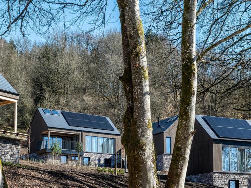 a house with solar panels on the side of it at Villa in Belgium with Private Terrace in La-Roche-en-Ardenne