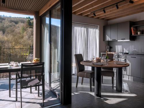 a kitchen and dining room with a table and chairs at Villa in Belgium with Private Terrace in La-Roche-en-Ardenne
