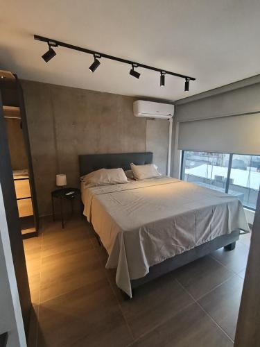 a bedroom with a large bed with lights above it at MOCA Living in Cali