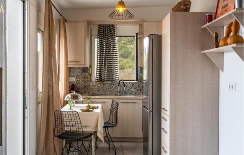 a kitchen with a table and chairs in a kitchen at Prinos 3 in Agia Galini