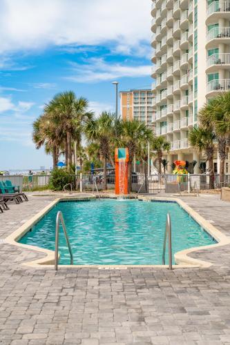 a swimming pool with a water slide in front of a building at Experience the ultimate beachfront lifestyle at Oceans One 1 Bdr with three queen beds in Myrtle Beach