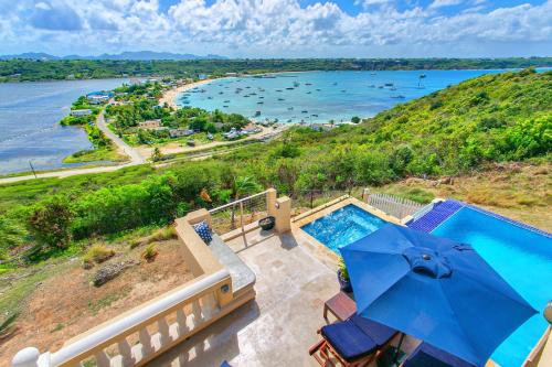 an aerial view of a swimming pool and the ocean at Villa Nirvana in North Hill Village