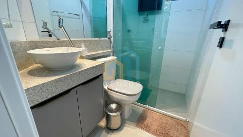 a bathroom with a sink and a toilet and a shower at Mahalo Flat Cabo Branco Genius Flats in João Pessoa