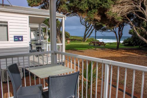 a porch with a table and chairs and the ocean at Tasman Holiday Parks - Yallingup Beach in Yallingup
