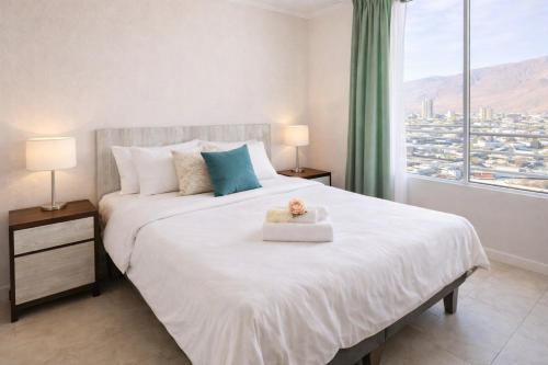 a bedroom with a bed with a teddy bear on it at Edificio iquique obispo labbe 830 in Iquique