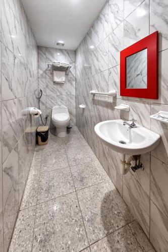a bathroom with a white sink and a toilet at Habitaciones Sky in Manta