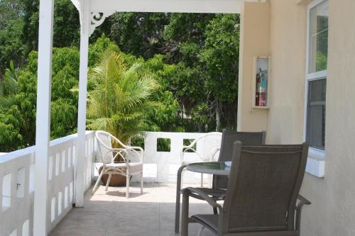 a porch with chairs and a table on a house at Venice Beach Villas in Venice