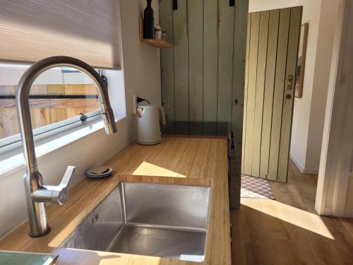 a kitchen with a sink and a counter top at Queen's Landing in Nelson