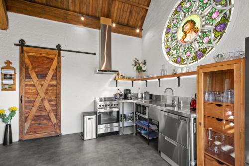 a kitchen with a stove and a stained glass window at The Church Millers Flat in Millers Flat