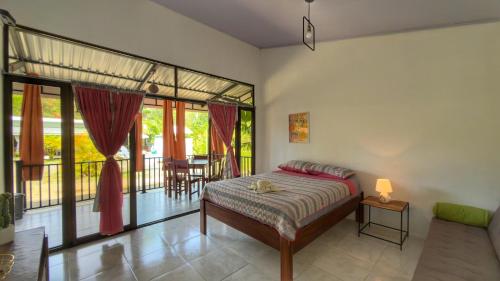 a bedroom with a bed and a balcony at La Jungla in Talamanca
