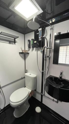 a small bathroom with a toilet and a sink at Casadana Riverview in Kampong Gemuroh