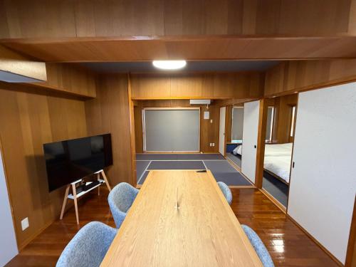 a conference room with a large wooden table and chairs at Kokusai Towns Inn in Naha