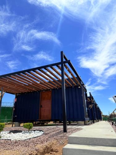 a building with a blue roof on a street at cabañas aldebaran in Ciénega Redonda