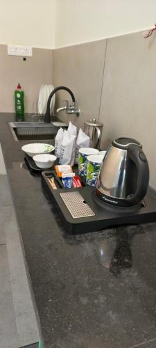 a kitchen counter top with a sink and a sink at IRIS urban stay in Cochin