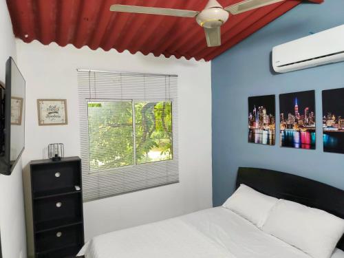 a bedroom with a white bed and a window at Casa Terraza in El Zaino