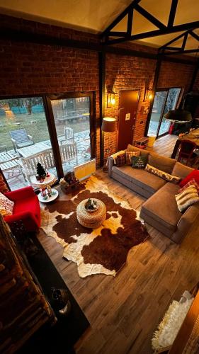 a living room with a rug on the floor at Uludag ztrk Mountain House in Kirazlı
