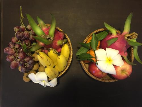 two baskets filled with different types of fruit at Hotel Five.S in Kampot