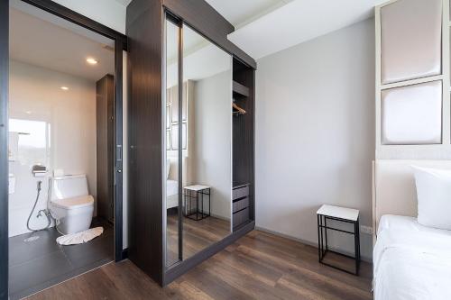 a small bathroom with a toilet and a mirror at Surin Condo Walk to Beach with Rooftop Pool - C416 in Ban Lum Fuang