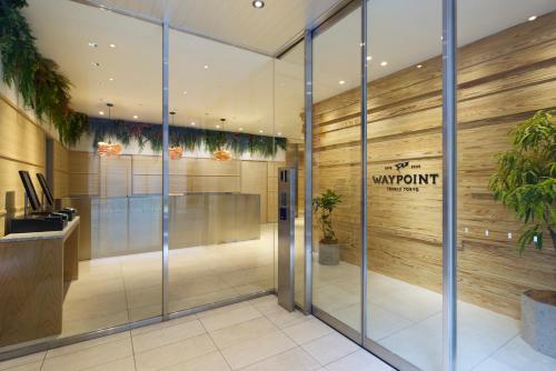 an office lobby with glass doors and a sign on the wall at WAYPOINT TSUKIJI Tokyo in Tokyo