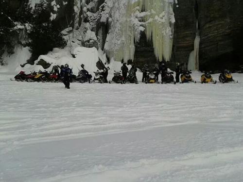 a group of people sitting in the snow at Little Hawk Resort & Marina in Algonquin Highlands