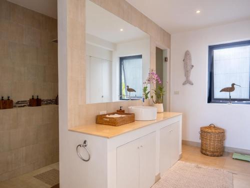 a bathroom with a sink and a mirror at Tropical Sea View 2Br Private Pool Villa in Plai Laem