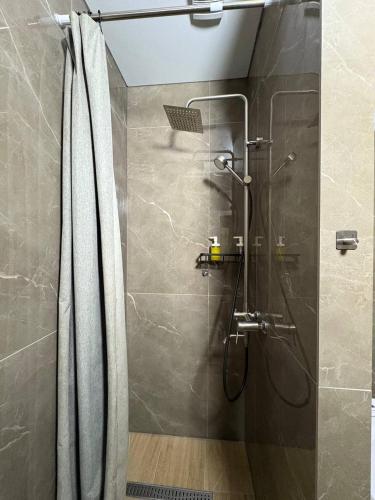 a shower with a glass door in a bathroom at Apart Rooms & Hostel 5 Capsule Rooms in Ustʼ-Kamenogorsk