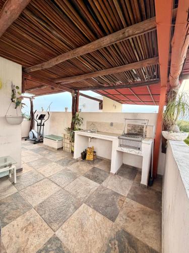 an outdoor patio with a bench and a table at Casa con terraza frente alberca in Tezoyuca