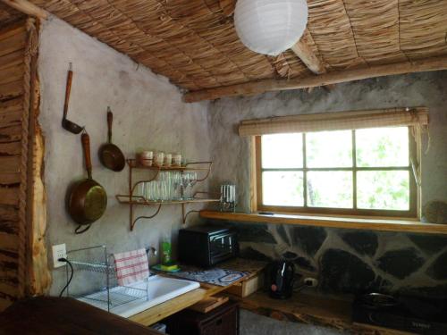 een keuken met een aanrecht, een raam en een wastafel bij El Cielo Lodge in San José de Maipo